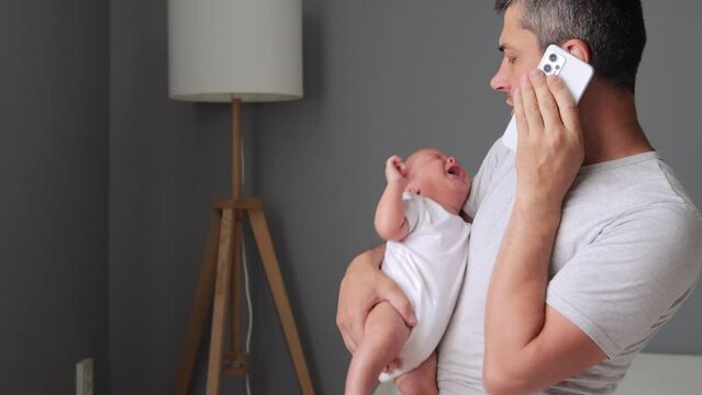 Parenthood problem. Panicking worried young father calling on phone needs for advice about his crying newborn baby boy talking with doctor or with mother for help