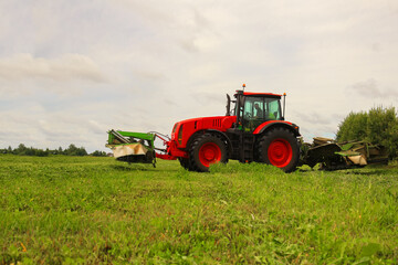 tractor, feed, harvesting, hay. A tractor mows the grass. haymaking, fodder harvesting. Copy space