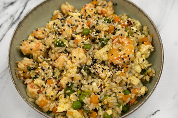 Chinese cuisine. Closeup view of a shrimp Chow Fan with rice, egg yolks and vegetables	
