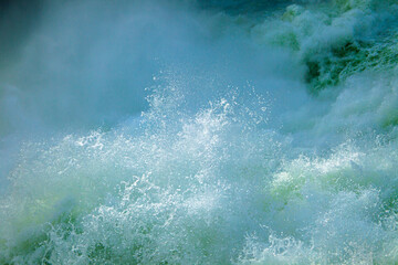 Powerful river water splashing with foam and bubbles