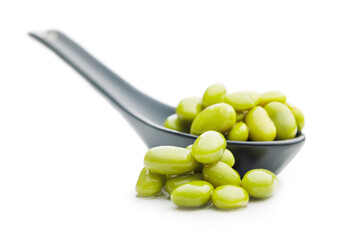 Edamame soy beans in ceramic spoon isolated on white background.