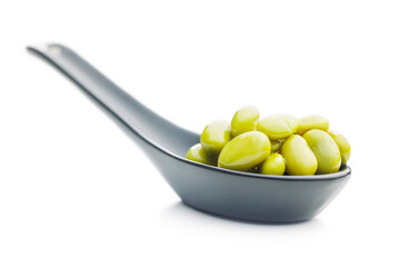 Edamame soy beans in ceramic spoon isolated on white background.