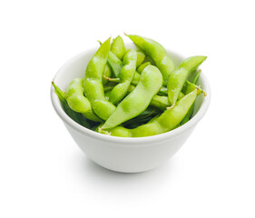 Green edamame pods. Fresh soybeans in bowl isolated on white background.