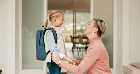 Mom, girl and happy at front door to school or education with pride, love and home. People, parent and kid or daughter with smile in morning with goodbye, support and excited for first day with trust