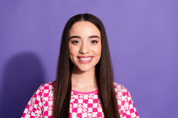 Fototapeta premium Photo of pretty young woman beaming smile empty space wear checkered t-shirt isolated on purple color background