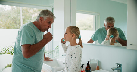 Grandparent, kid and brushing teeth in bathroom for care, dental health and learning oral hygiene. Child, grandfather and girl with toothbrush for cleaning, wellness or morning routine in family home