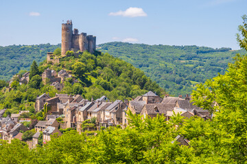 Castle of Najac towering above village houses,  photographed in Occitanie region
