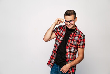 Man in Red Plaid Shirt Adjusts Glasses