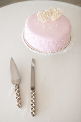 Pink Wedding Cake With Heart Toppers