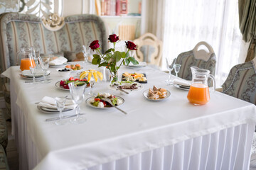 Elegant Dinner Table Setting With Rose Centerpiece