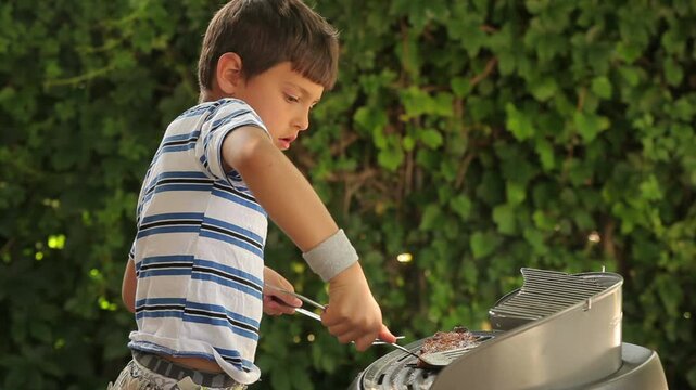 Bboy cooking steak on gas grill outdoors. High quality 4k footage