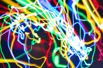 Abstract freezelight background of multicolored fancy stripes of light on a black.