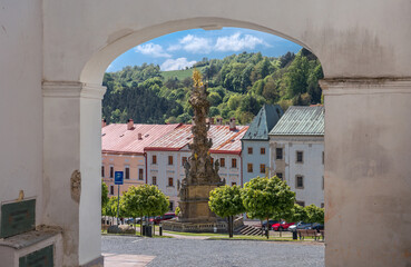 The view on Plague column through an arch - Kremnica, Central Slovakia