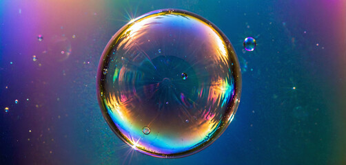 The refraction and interference of light on the thin surface layer of a soap bubble causes it to shine very colorful