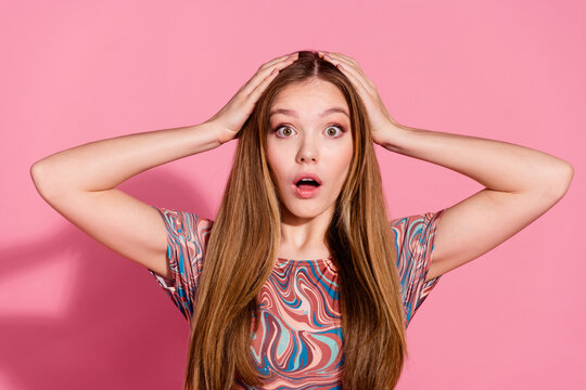 Photo of stunned lovely girl with straight hairdo dressed print shirt palms on head staring at promo isolated on pink color background