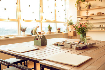 Beautiful interior with flower pots and a table in the middle of the room