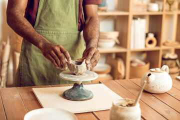 Close up of sculptors hands working with clay