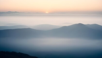 mountain layers and sunrise view in cold and foggy weather.