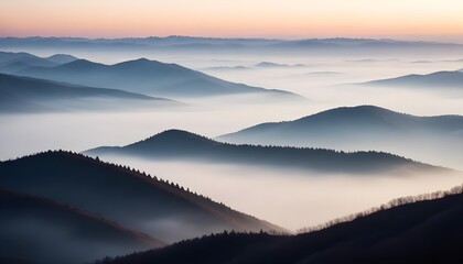 Obraz premium mountain layers and sunrise view in cold and foggy weather.