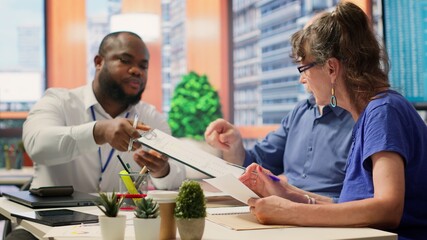 Senior clients asking a financial advisor about various retirement options, protecting their life savings and pension for future stability. Counseling to increase their income. Camera A.