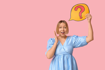 Surprised adult woman holding speech bubble with question mark on pink background