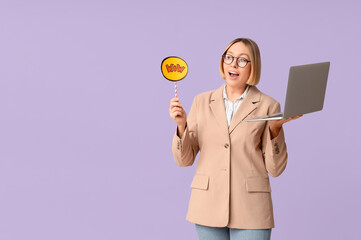 Surprised adult woman with laptop holding speech bubble with word WOW on lilac background