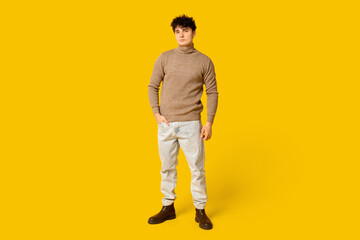 Fototapeta premium Handsome young man in stylish clothes on yellow background