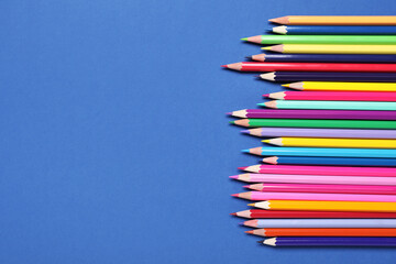 Set of colorful pencils on blue background