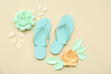 Composition with stylish flip-flops and paper flowers on color background
