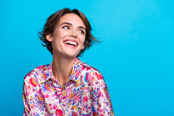Fototapeta premium Portrait of stunning cheerful person beaming smile look empty space inspiration isolated on blue color background