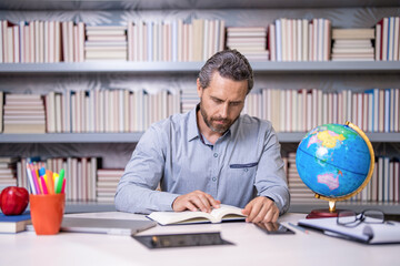 back to school. geographer teacher at school. Millennial school teacher of geography. Man teaching geography lesson in class. teachers day. Educational programs. teacher with globe. school education