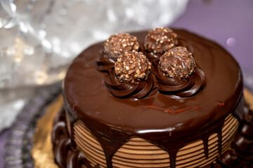 A dark chocolate cake with chocolate decorations