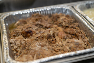 Shredded meat at an event in catering disposable dishes