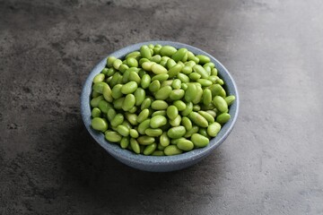 Raw green edamame soybeans on grey table