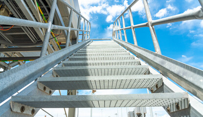 A metal staircase leads up to the gas cooling unit. Concept of nature and production