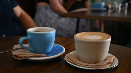Two cups of coffee on a table - profile view