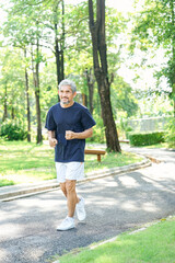 healthy senior man jogging in the summer park,concept of elderly people lifestyle,health care,wellness,wellbeing