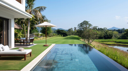 Fototapeta premium Hotel swimming pool accommodation by green grass for relax vacation