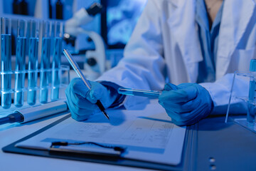 scientist is working on an important liquid inside tube in laboratory, the discovery of a vaccine...