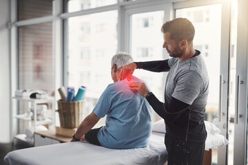 Fototapeta premium Physiotherapy, shoulder pain and man with senior patient for orthopedic care, consulting and wellness. Chiropractor, health and physical therapist with person for rehabilitation, support and healing