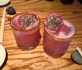 stunning dragonfruit cocktail with a well garnished and sugar coated rim