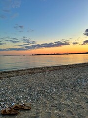 sunset on the beach with flip flops