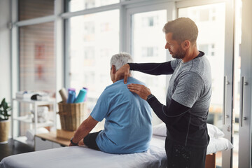 Physiotherapy, shoulder pain and person with senior man for medical care, consulting and wellness. Chiropractor, healthcare and physical therapist and client for rehabilitation, massage or assessment