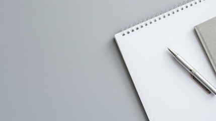 White paper and pen on gray background with space for text top down view of work area