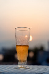 Sunset with half glass of beer