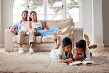 Happy family, relax and kids reading book in home for learning, bonding or knowledge together. Smile, education and parents with kid siblings storytelling for fairytale, fantasy or child development