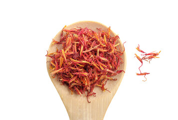 Healthy Dried safflower petals herb tea in wooden spoon on white background with clipping path....