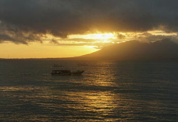 Fototapeta premium Fishing boats go out to sea at sunrise.