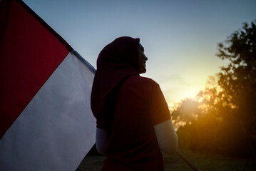 Portrait of a woman holding an Indonesian flag