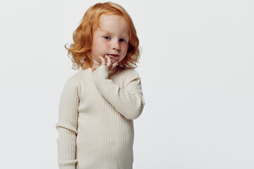Redhaired little girl contemplating against white background beauty and innocence portrayed in...